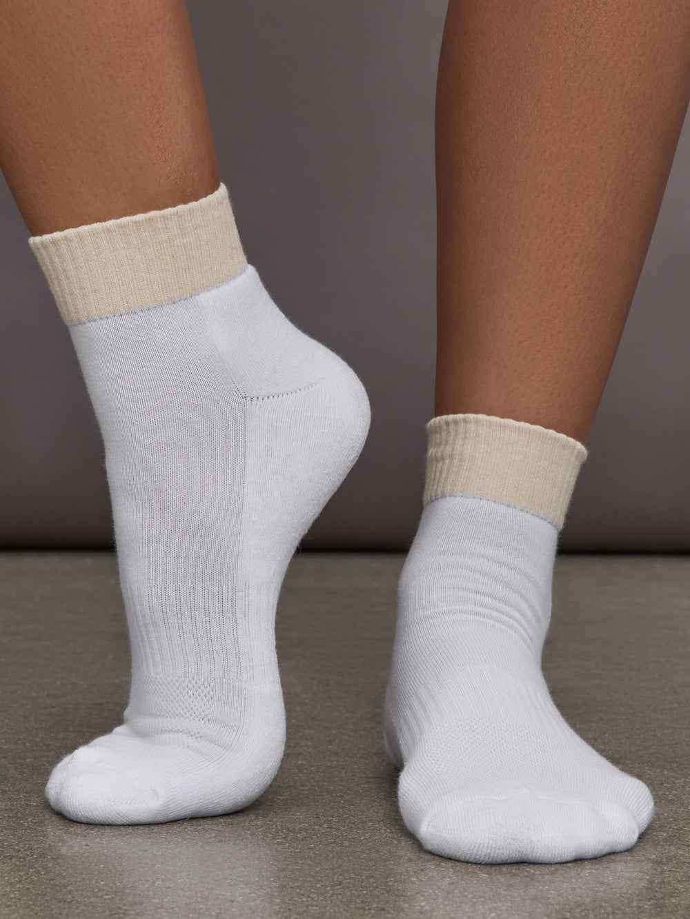 Champagne and white colored socks with contrast design.


