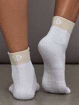 Champagne and white colored socks with contrast design.
