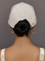 Model wears an off white baseball cap with Goldbergh logo on front.