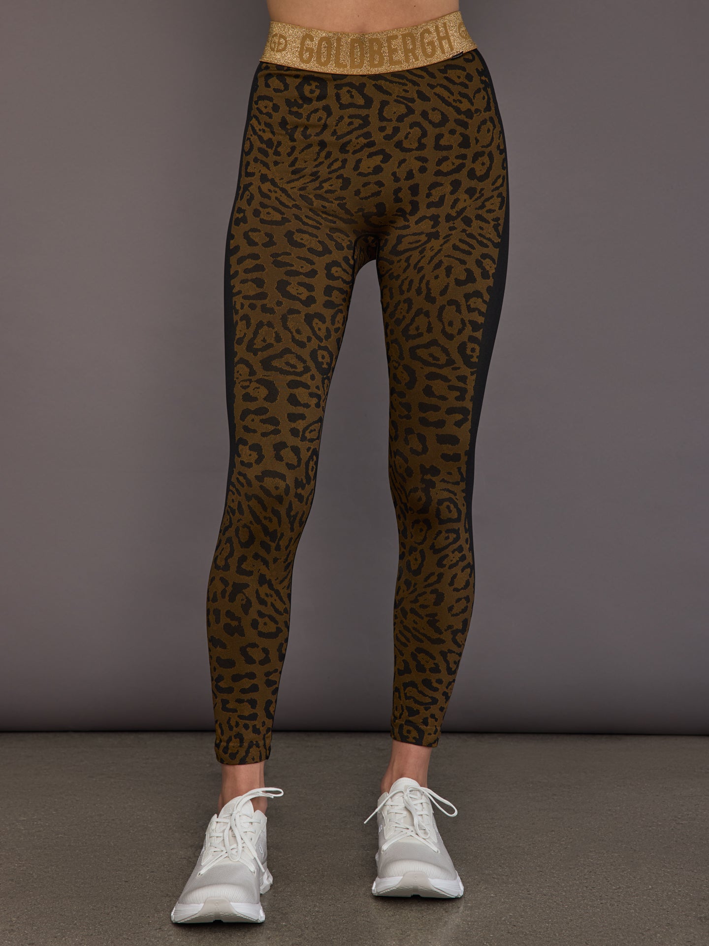 Model wearing leopard seamless base layer leggings, front view.