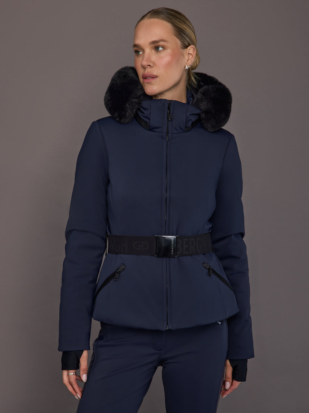 Model wearing navy faux-fur trim ski jacket, front view.
