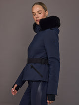 Side view of navy ski jacket showing belted waist and hood detail.