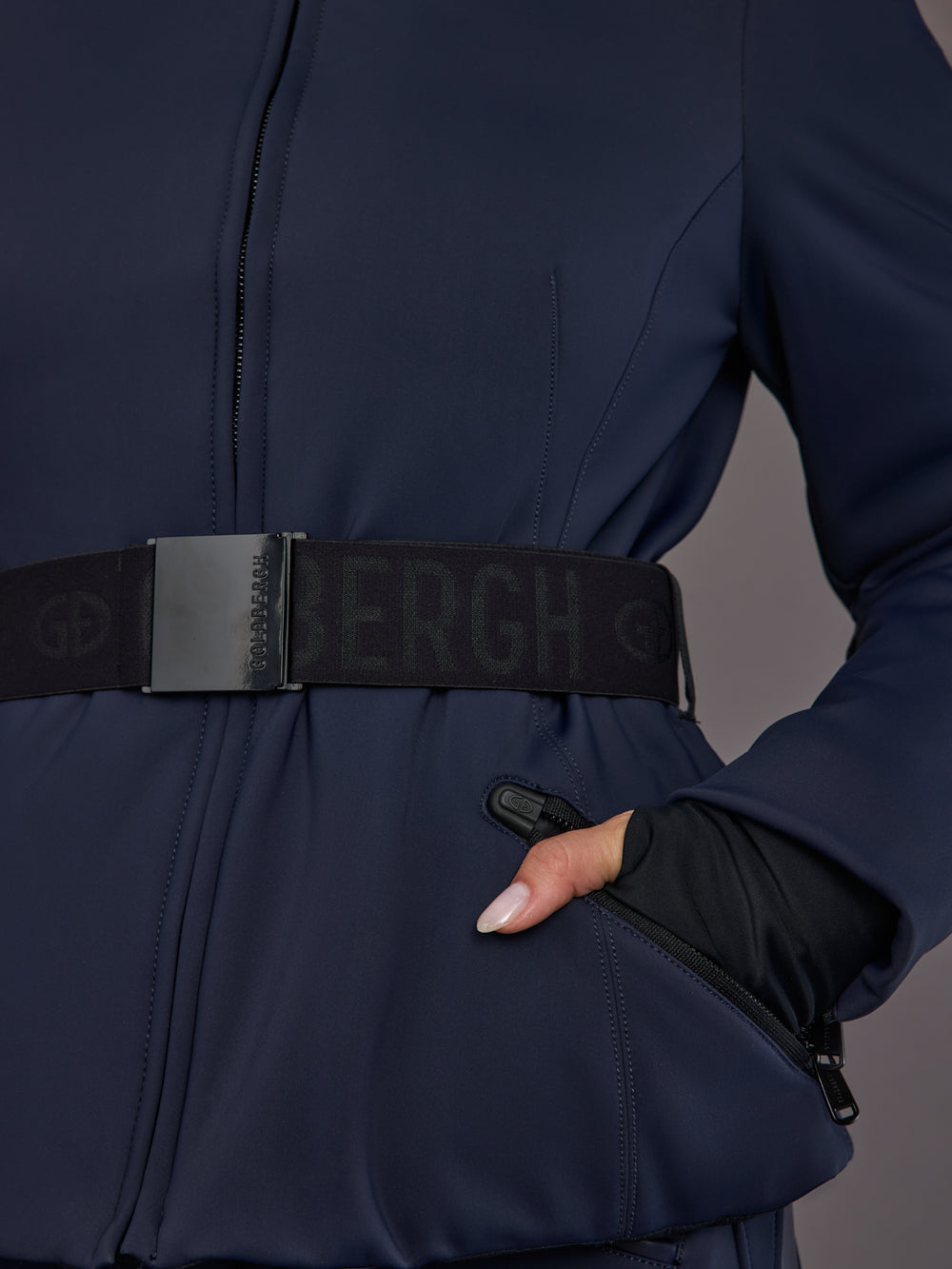 Close-up of black elastic logo belt on navy ski jacket.