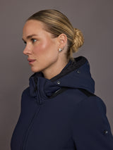 Profile view of model wearing navy ski jacket with hood.