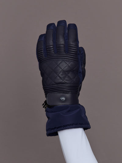 Close-up of quilted leather navy ski glove, top view.