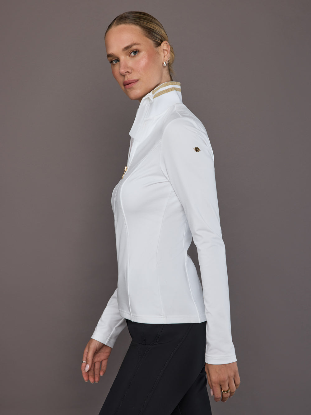 Model wearing white ski pully, side view.
