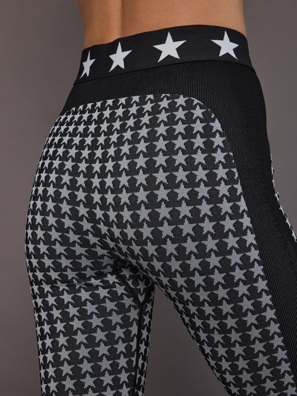 Close-up of black white star seamless baselayer tight, waistband and pattern detail.