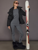 Full body view of the Starlet Seamless Baselayer Long Sleeve in Black White Star worn with matching tights and ski gear.