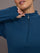 Model is wearing a blue quarter zip long sleeve fitted top 