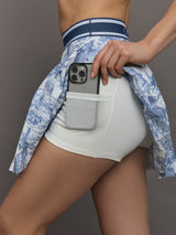 Blue pleated toile patterned skirt with navy waistband.