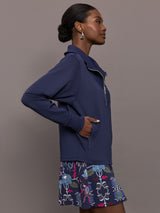 Model wearing a blue quarter zip sweatshirt