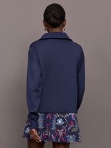 Model wearing a blue quarter zip sweatshirt