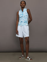 Model wears sleeveless quarter-zip top with a slim, athletic fit and a high collar.