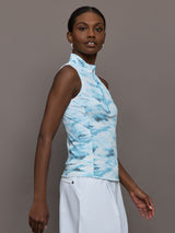 Model wears sleeveless quarter-zip top with a slim, athletic fit and a high collar.