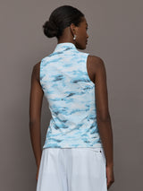 Model wears sleeveless quarter-zip top with a slim, athletic fit and a high collar.