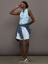 Model wears sleeveless quarter-zip top with a slim, athletic fit and a high collar.