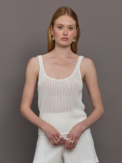 Model wears a white knit wide neck mesh patterned tank.