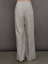 Model wears a pair of gray/taupe oversized wide leg woven work trousers.