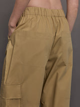 Model wears a pair of mid rise khaki cargo wide leg pants.