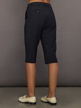 Model wears black capri pants with a mid-rise.