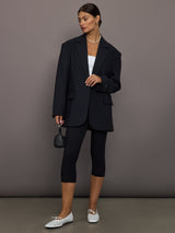 Model wearing a black oversized blazer with pockets.
