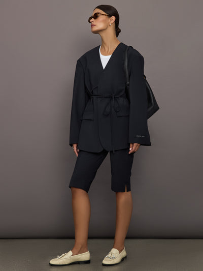 Model wearing a black oversized blazer with pockets.