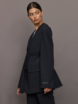 Model wearing a black blazer with a front tie.
