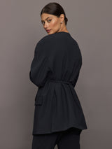 Model wearing a black blazer with a front tie.