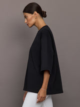 Model wearing a black oversized t-shirt with 'Herskind' text.