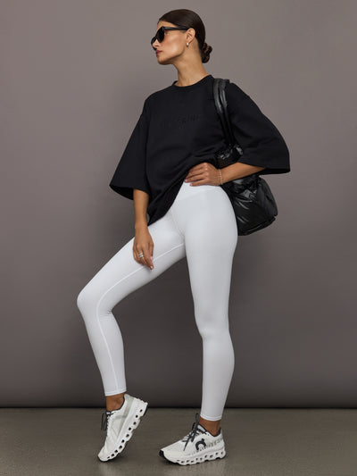 Model wearing a black oversized t-shirt with 'Herskind' text.