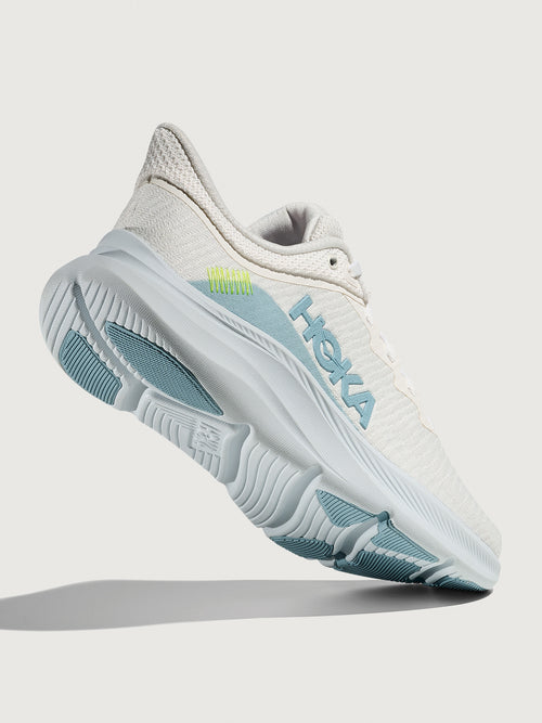White HOKA running shoe with blue logo and accents on a white background