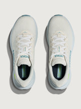 White HOKA running shoe with blue logo and accents on a white background