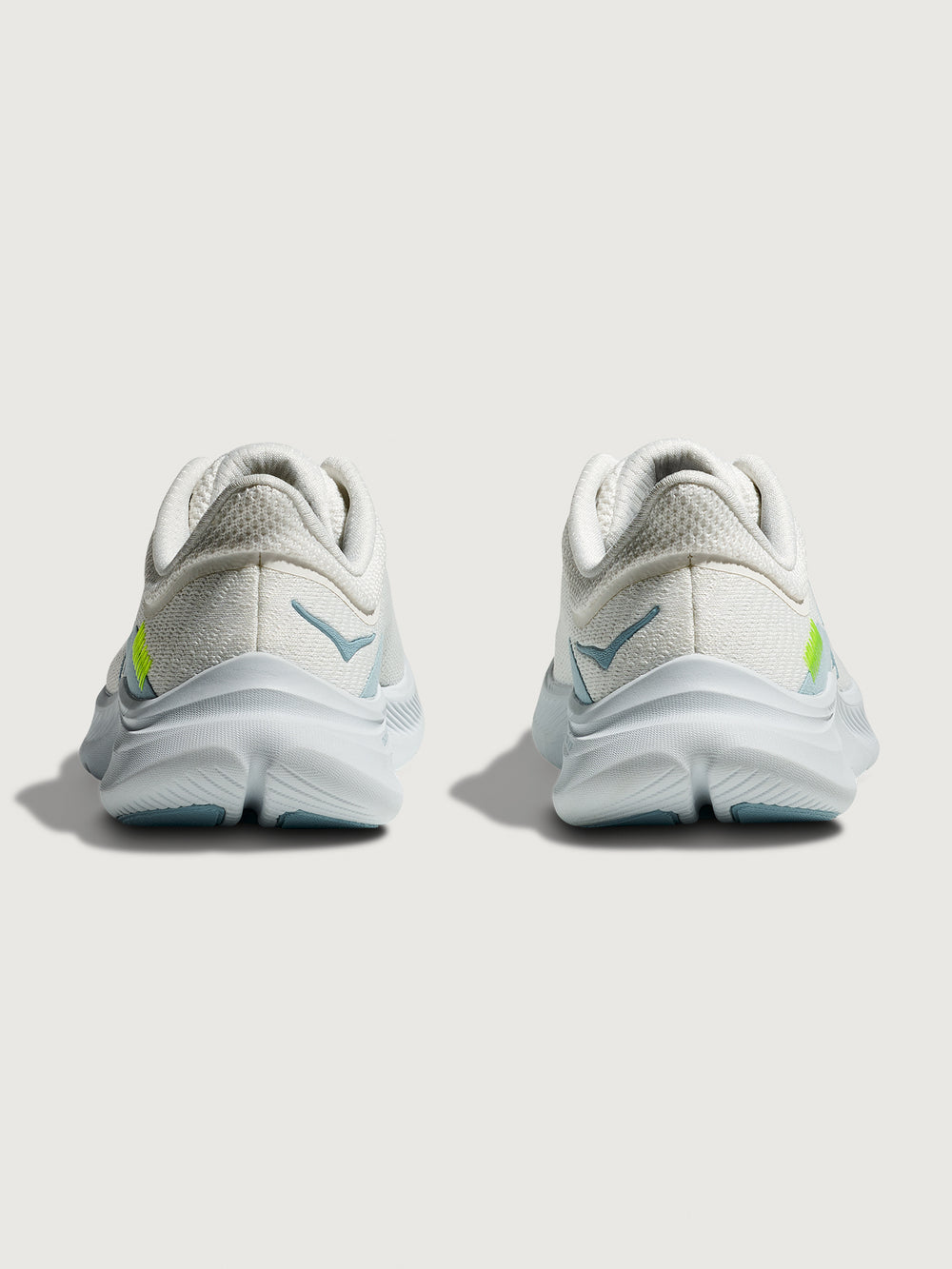 White HOKA running shoe with blue logo and accents on a white background