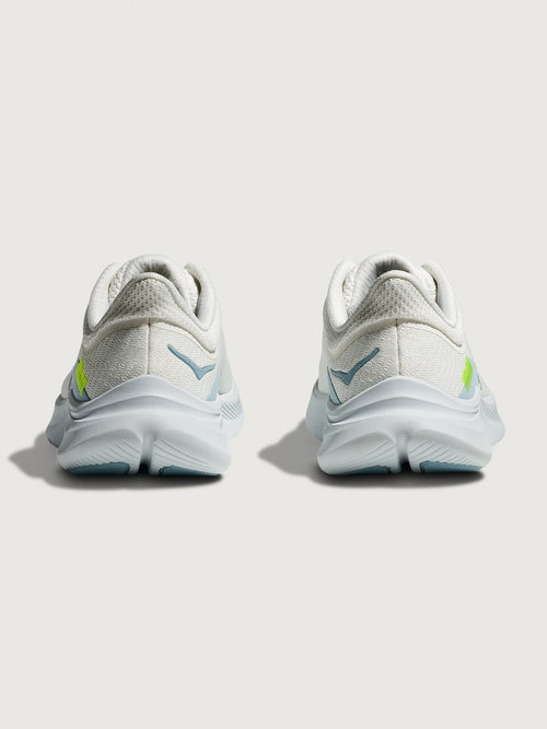 White HOKA running shoe with blue logo and accents on a white background