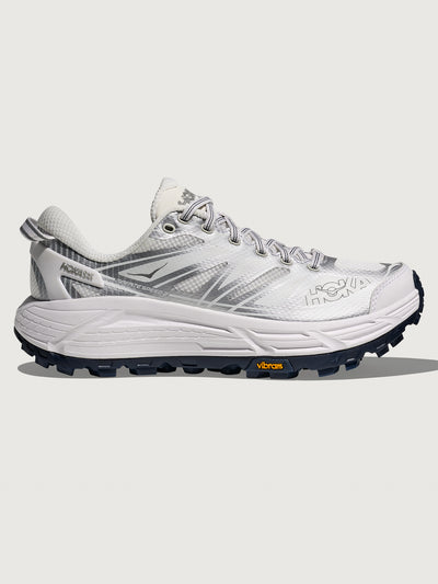White hiking shoe with black sole on a white background