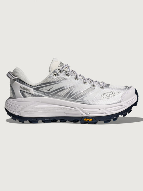 White hiking shoe with black sole on a white background