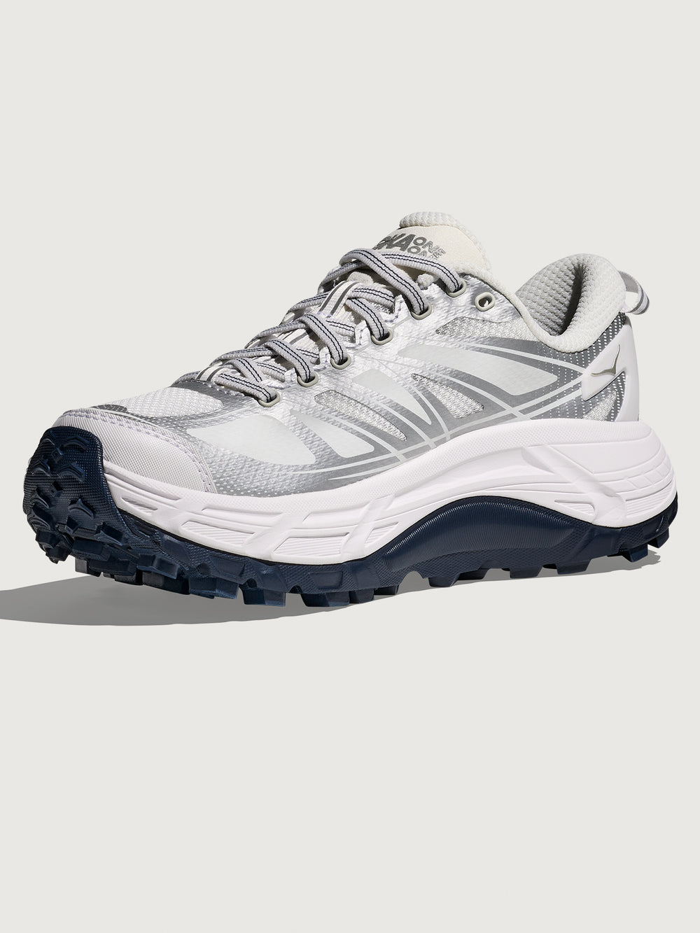 White and gray athletic shoe with a black sole on a light gray background