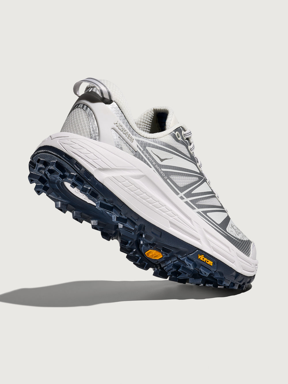 Gray and white athletic shoe with blue sole on a light gray background