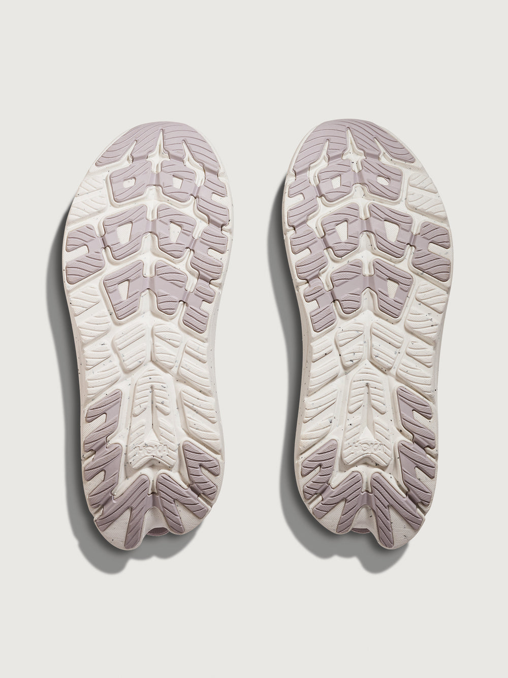 Two shoe insoles with tread pattern on a light gray background
