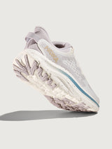 White running shoe with blue accents on a light gray background