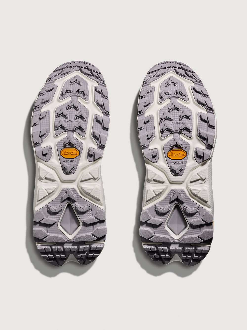 Pair of gray and white shoe soles on a light gray background