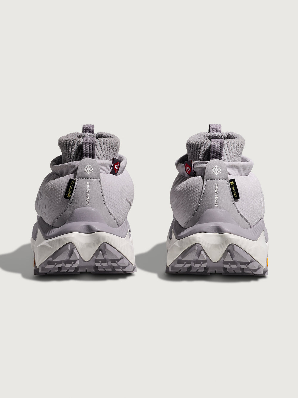 Gray hiking boots with unique sole design on a light gray background