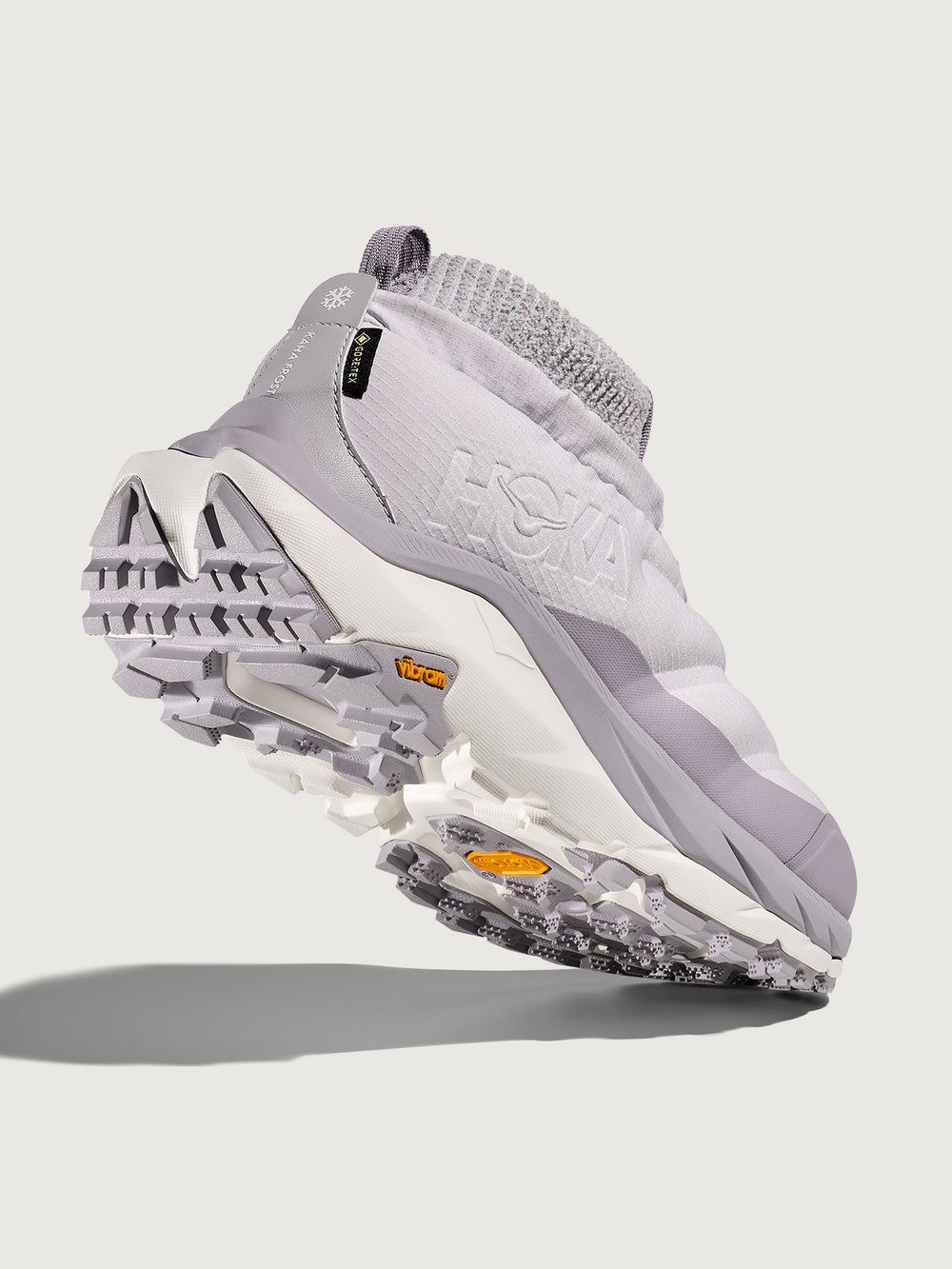 Gray and white athletic shoe on a light gray background