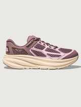 Purple running shoe with beige sole on a light gray background