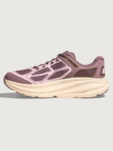 Pink running shoe with a thick white sole on a light gray background