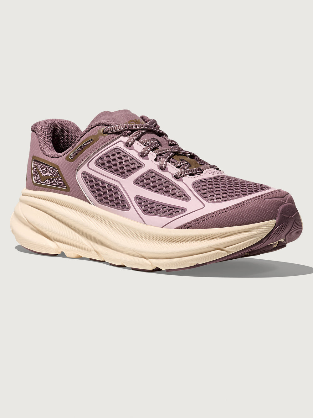 Pink running shoe with a white sole on a light gray background