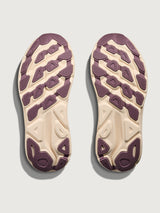 Top view of a pair of shoes with purple soles on a light gray background