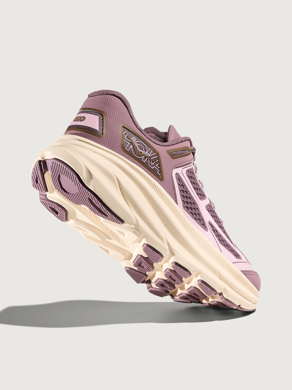 Purple and beige sneaker on a light gray background