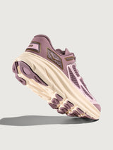 Purple and beige sneaker on a light gray background