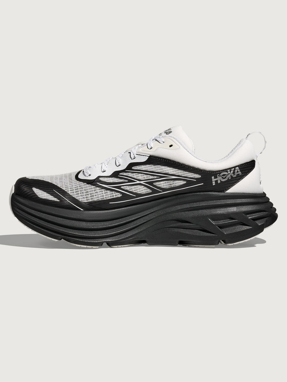 Black and white running shoe with 'Hoka' branding on a light gray background
